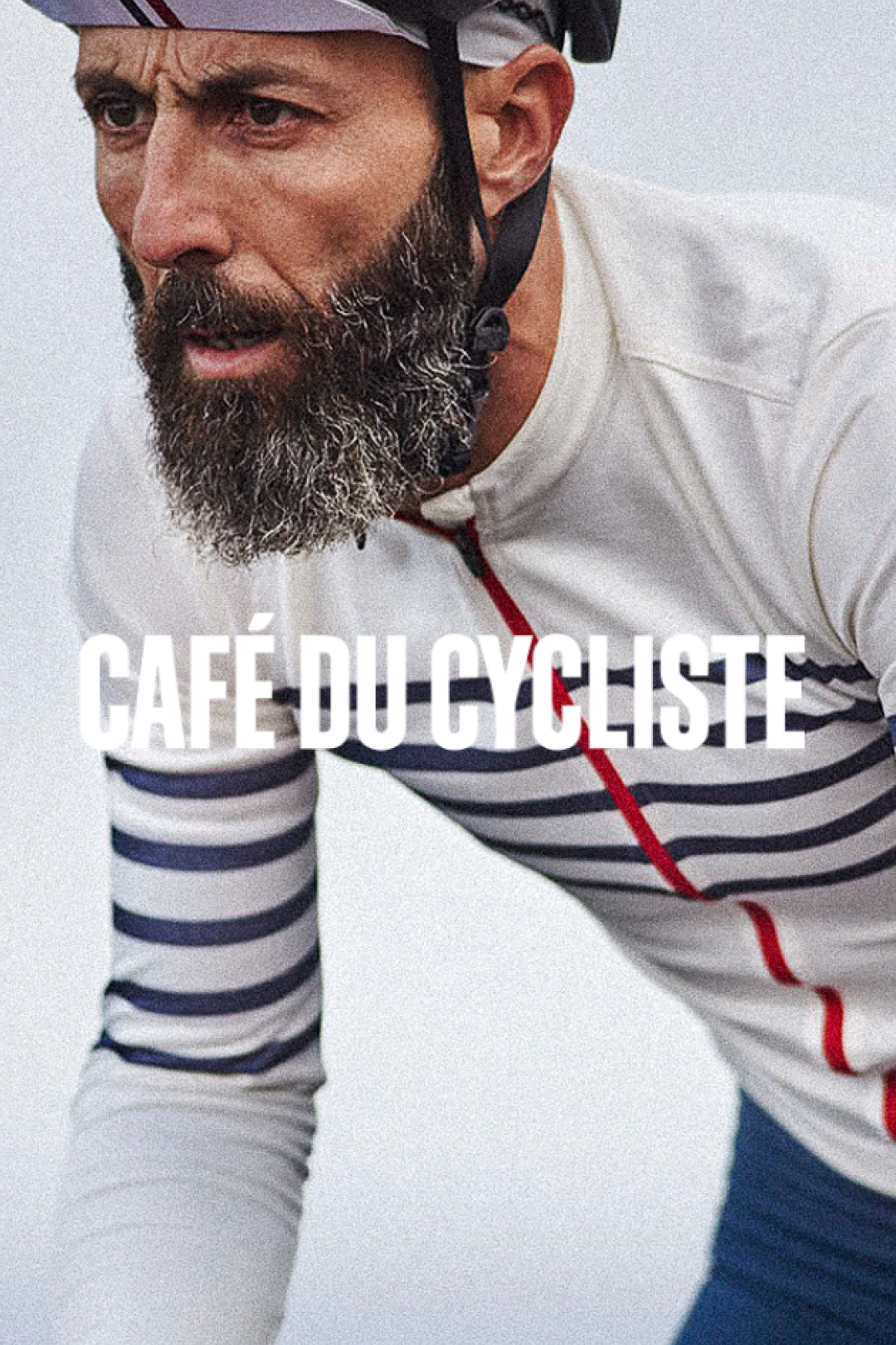 Focused cyclist in a Café du Cycliste striped jersey looking intently forward @ Bici.