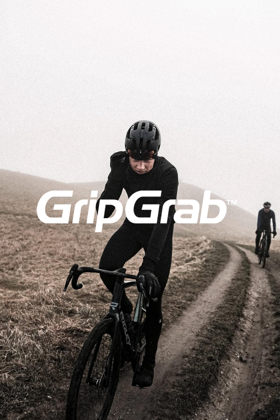 Cyclist wearing GripGrab apparel riding solo on a misty countryside road @ Bici.