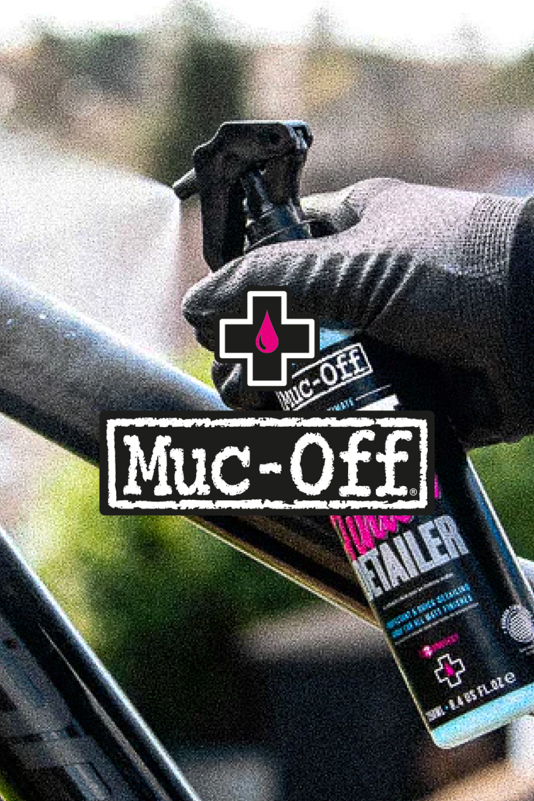 Hand in a glove applying Muc-Off lubricant to a bike chain, emphasizing bike maintenance @ Bici.