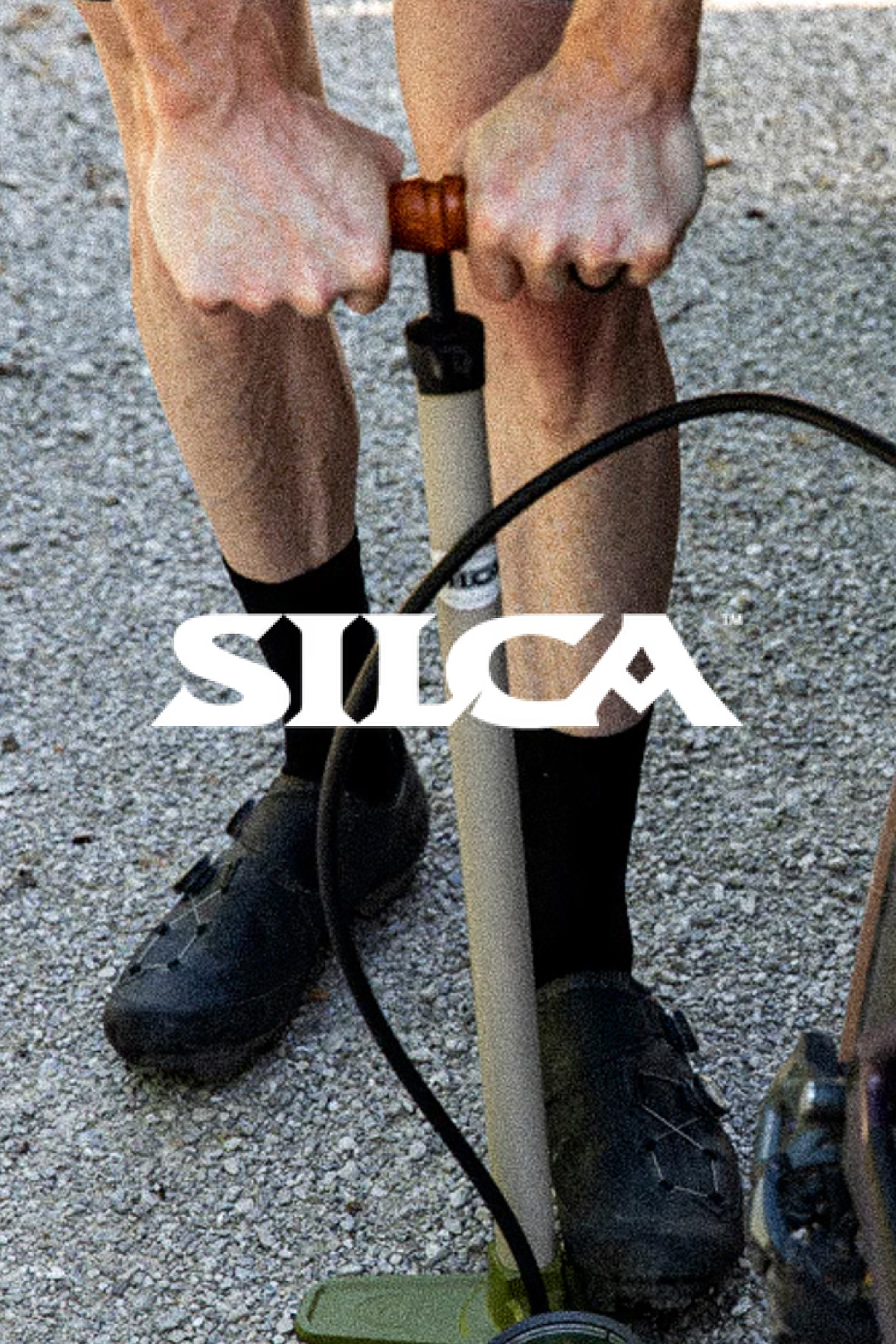Cyclist using a classic SILCA floor pump to inflate bike tires before a ride @ Bici.