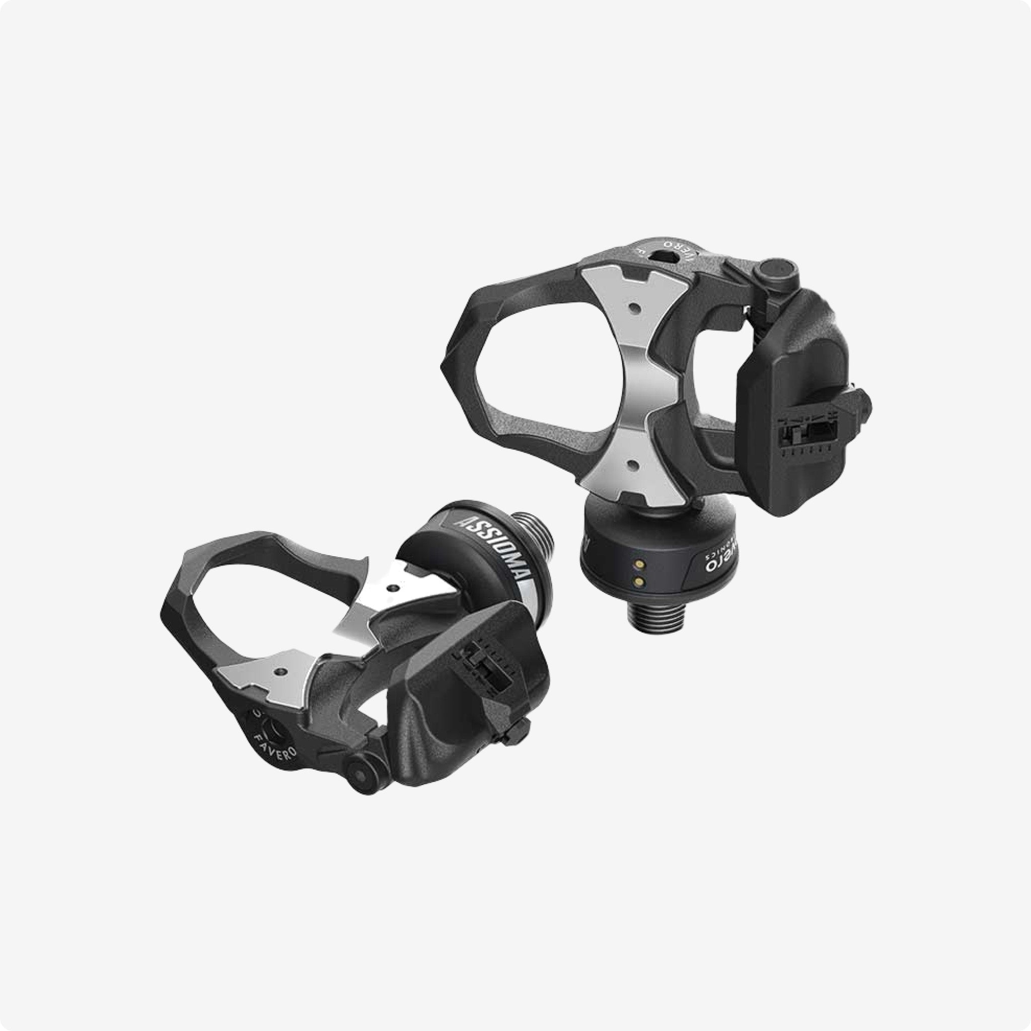 Pair of Favero black and silver cycling clip-in power meter pedals, showcasing advanced technology for performance enhancement @ Bici.