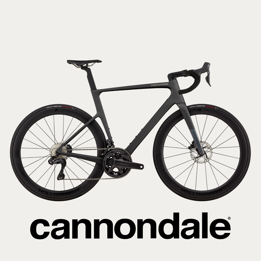 A modern Cannondale road bike displayed against a plain background, highlighting its sleek design and advanced components @ Bici.