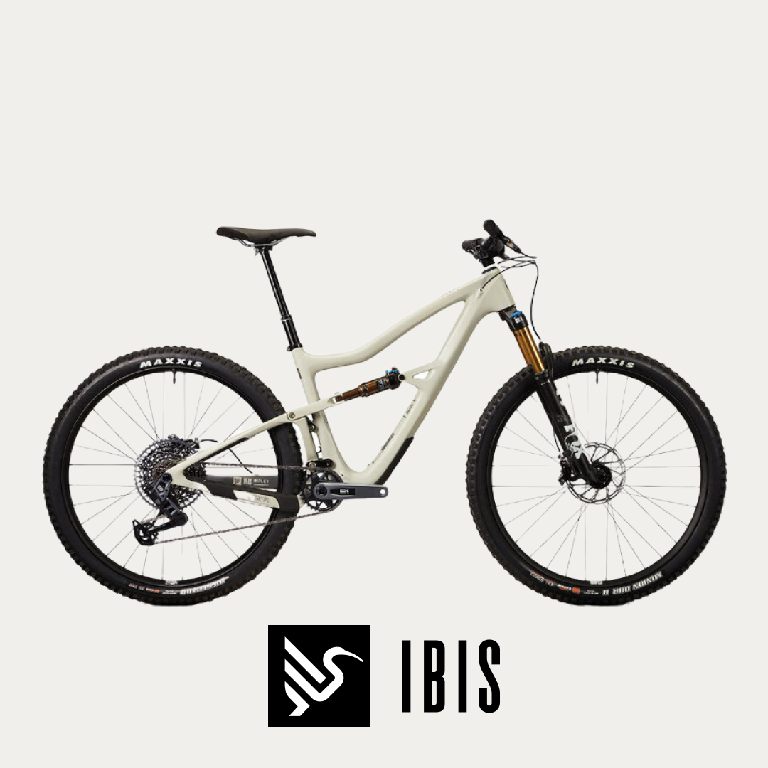 A pristine Ibis mountain bike is showcased against a white background, its full-suspension frame ready to tackle rugged trails @ Bici.